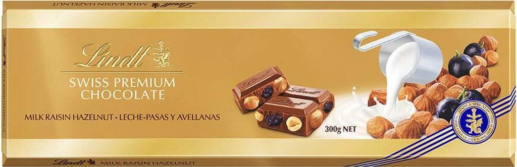 A chocolate bar package with images of chocolate pieces, milk, raisins, and hazelnuts.