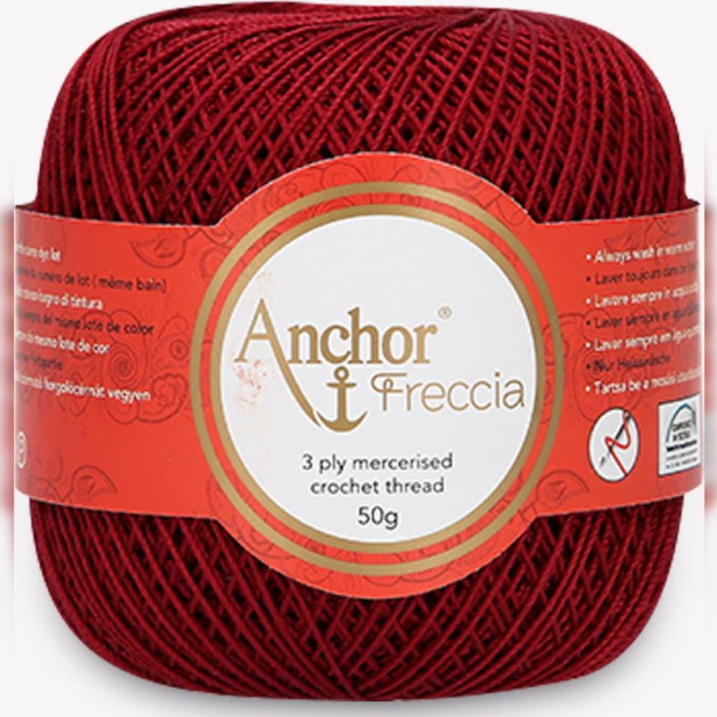 A ball of red crochet thread with a label.