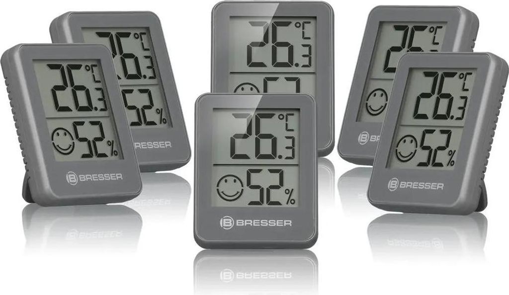 A set of six digital thermometers and hygrometers are arranged in a cluster on a white background.