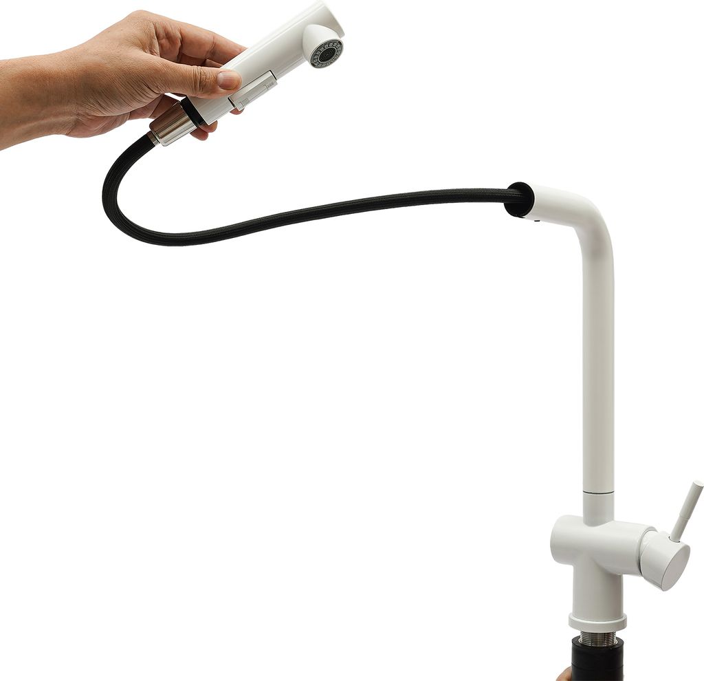 A hand holding a white pull-down kitchen faucet spray head, connected by a black hose to the main white faucet body.