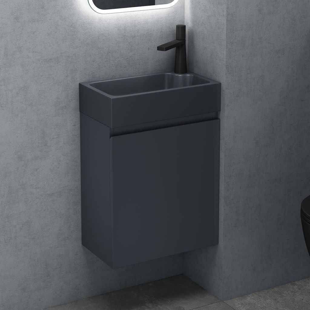 A modern bathroom vanity with a sink and faucet against a concrete wall.