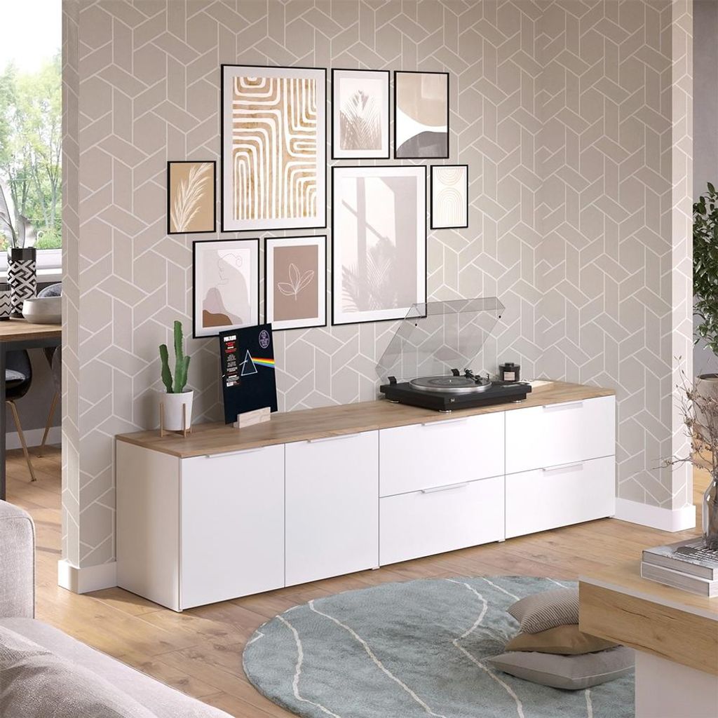 A living room scene with a media console, record player, and artwork on the wall.