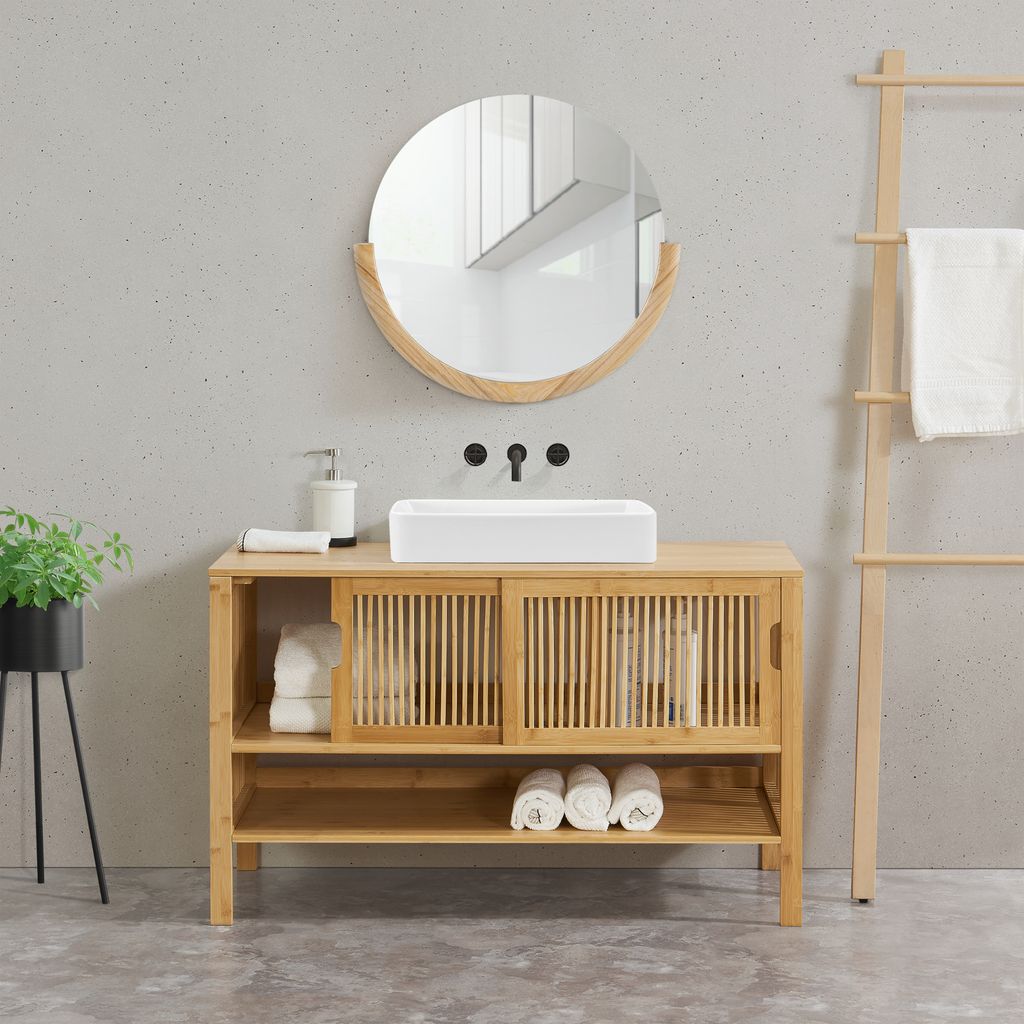 A bathroom vanity with a sink and mirror.