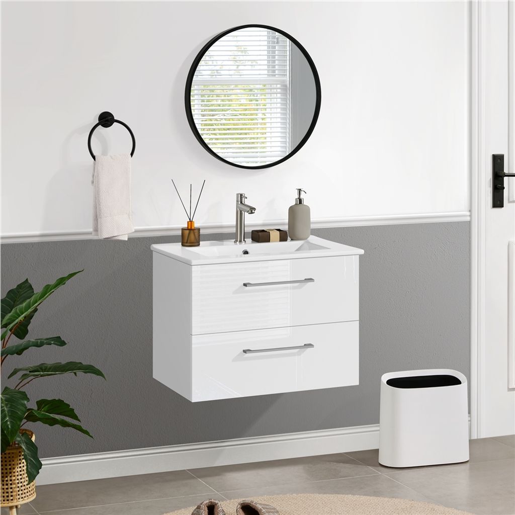A modern bathroom vanity with a sink and faucet, a round mirror, a towel rack, and a trash can.