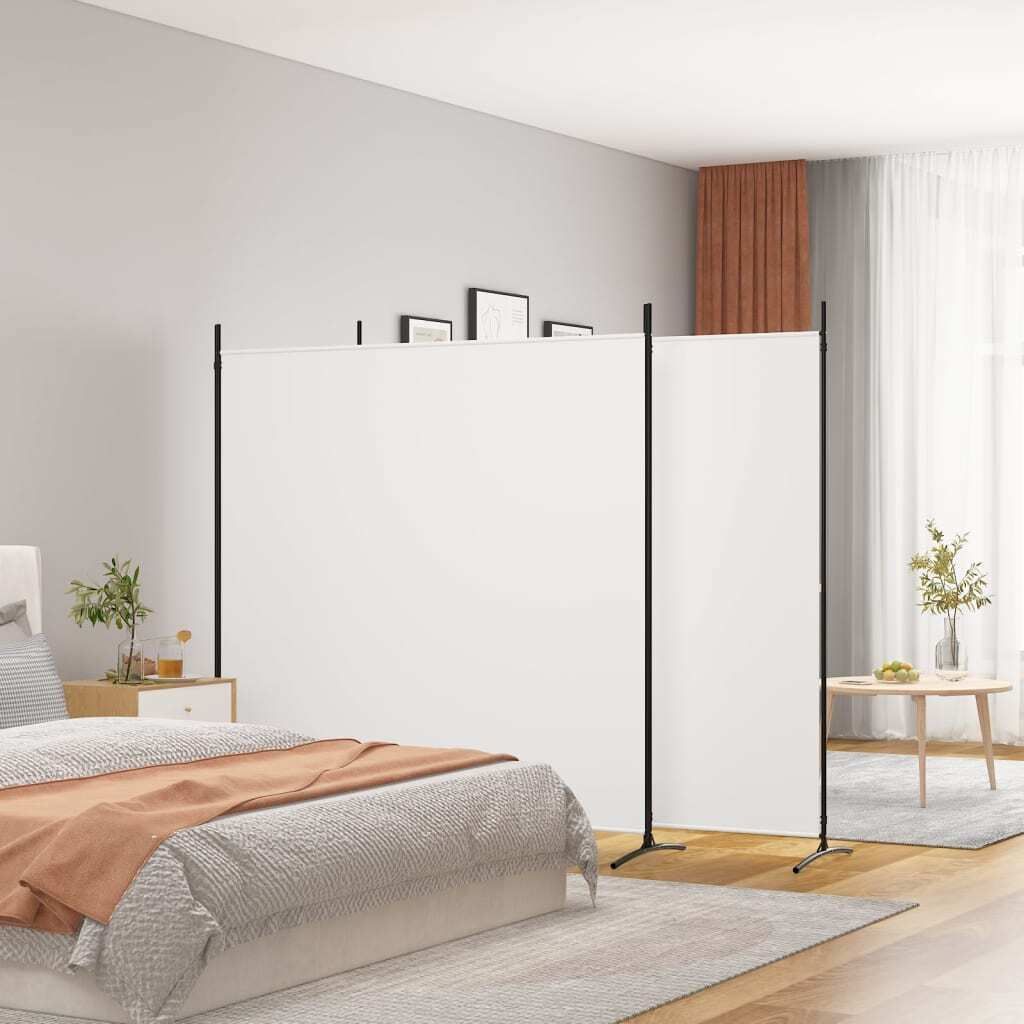 A bedroom scene with a white room divider set up to separate the bed area from another part of the room.