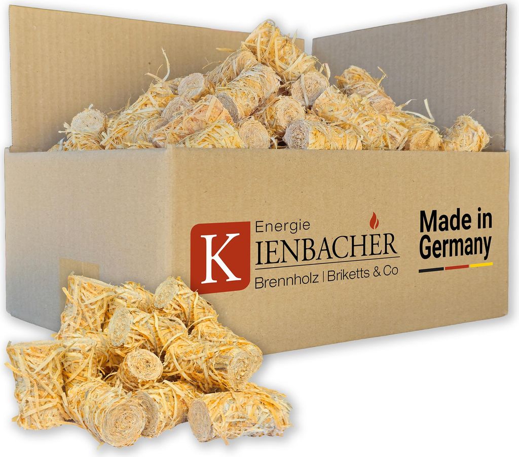 A cardboard box filled with wood wool fire starters, with some spilled in front.