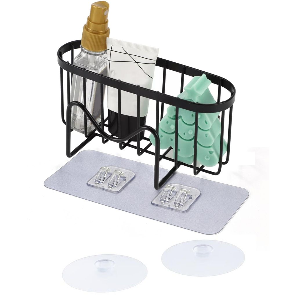 A black wire rack for a sink, holding a spray bottle, a tube of cream, and a green sponge. It is attached to a grey pad with two clear adhesive hooks.