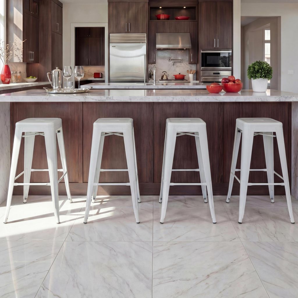 A modern kitchen with a breakfast bar and white metal stools.