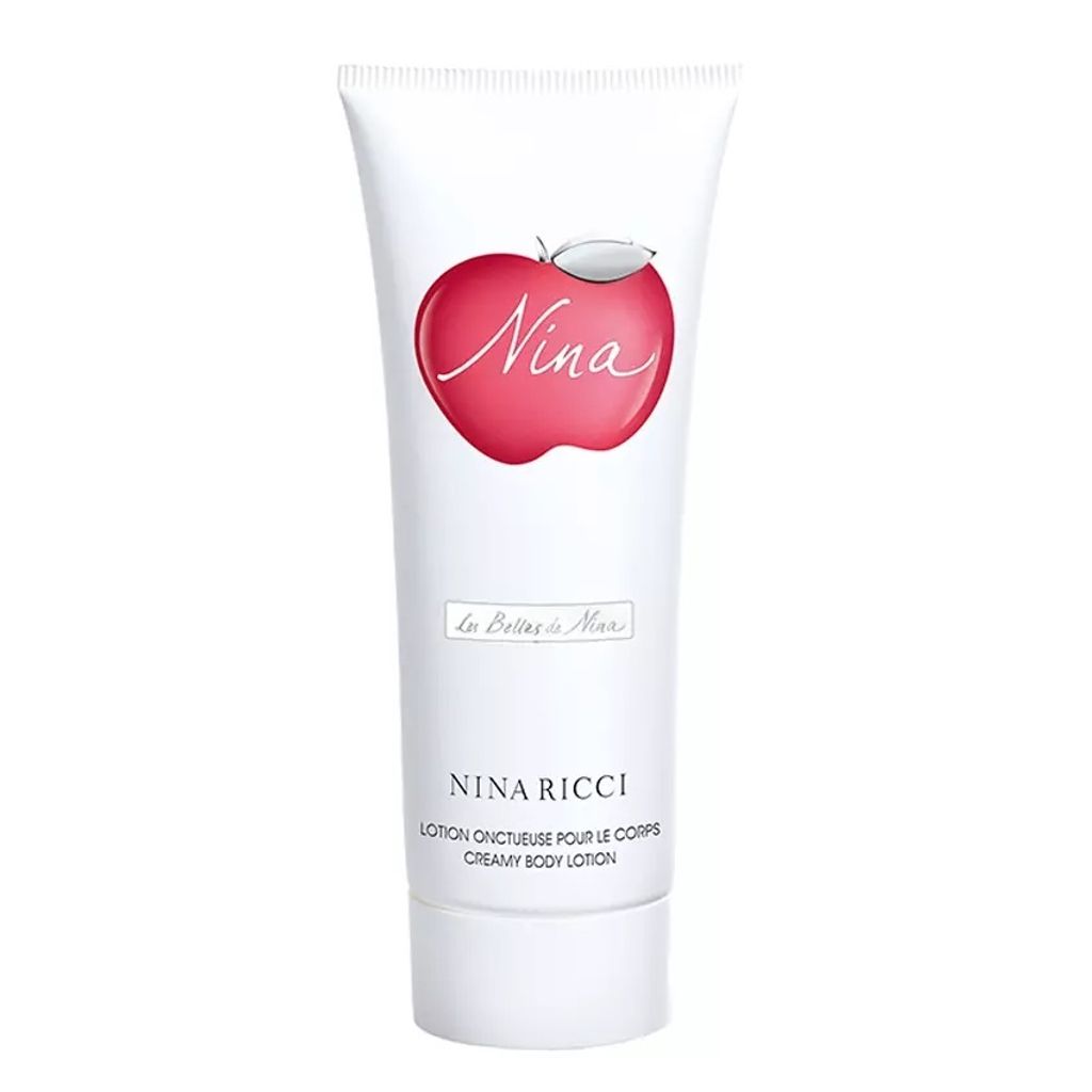 A white tube of Nina Ricci Nina Creamy Body Lotion with a red apple logo.