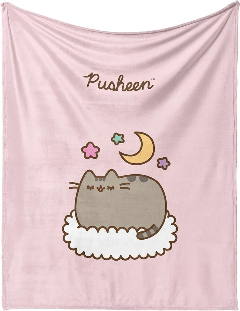A pink blanket with a cartoon Pusheen cat sleeping on a cloud, surrounded by stars and a moon.