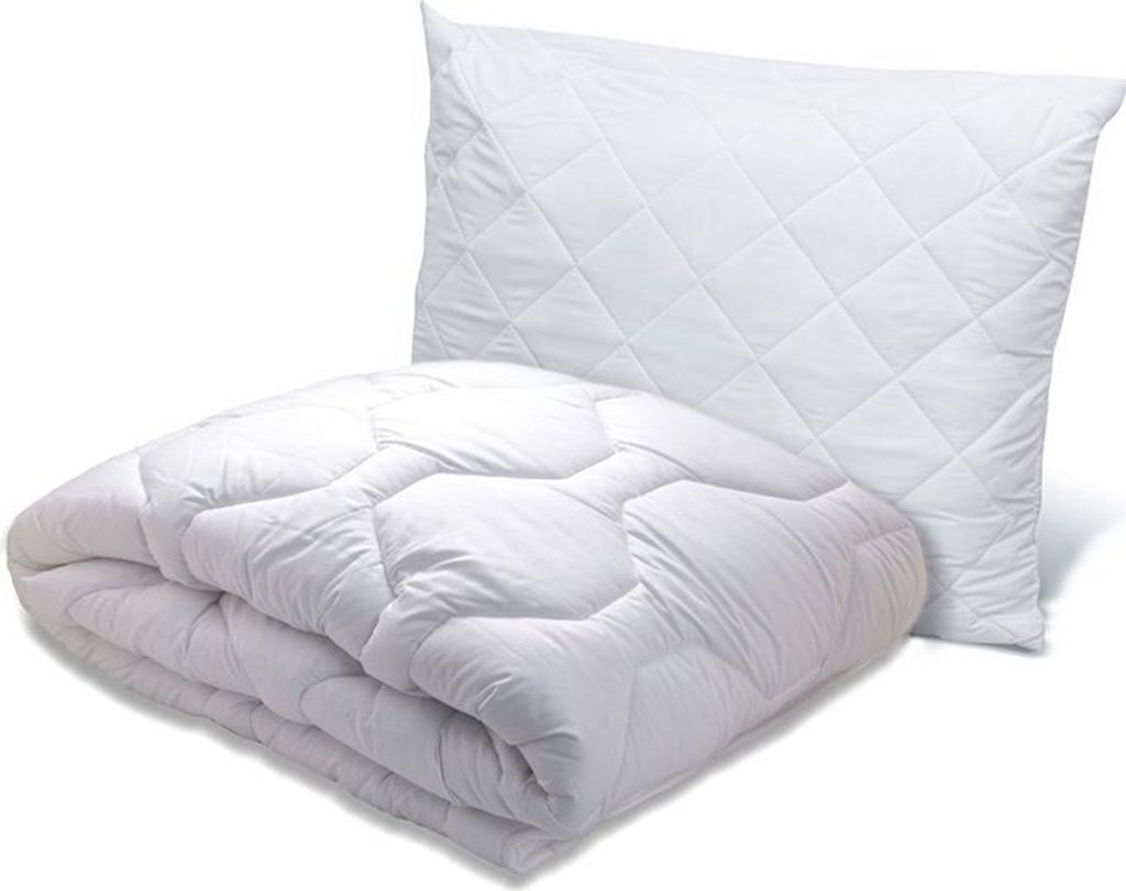 A white quilted pillow and a folded white quilted comforter are shown against a white background.