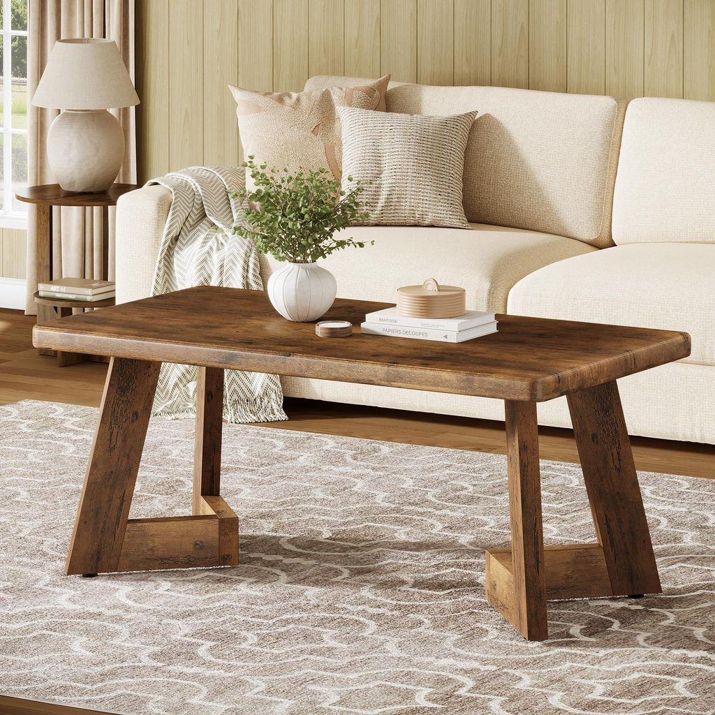 A living room scene with a couch, coffee table, and lamp.
