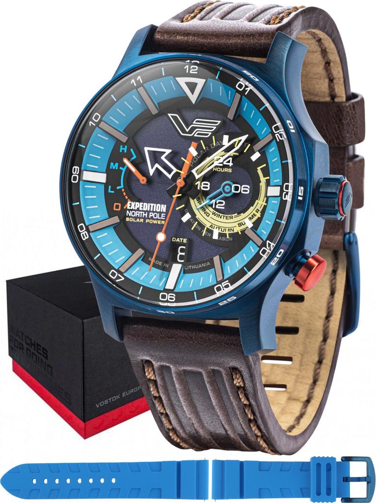 A Vostok Europe watch with a blue dial and brown leather strap, shown with its box and an extra blue strap.