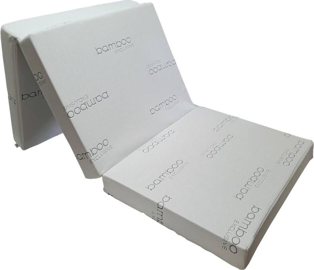 A folded white mattress with "bamboo EXCLUSIVE" branding visible on its surfaces.
