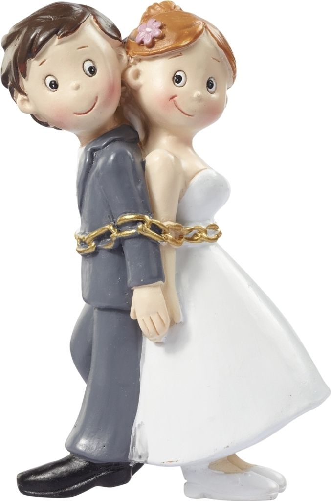 A wedding cake topper of a bride and groom chained together.