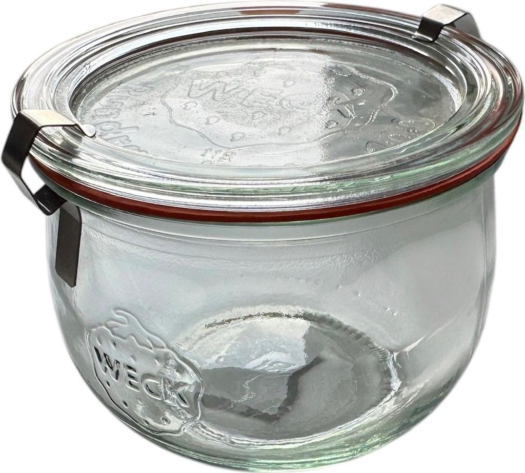 A clear glass jar with a red rubber seal and silver metal clasps, sitting on a white background.