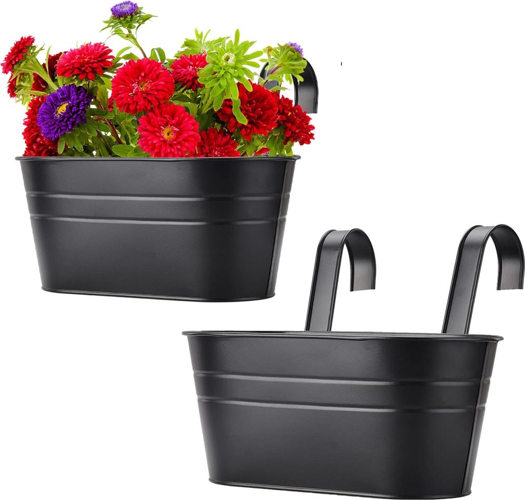Two black hanging planters, one filled with colorful flowers.