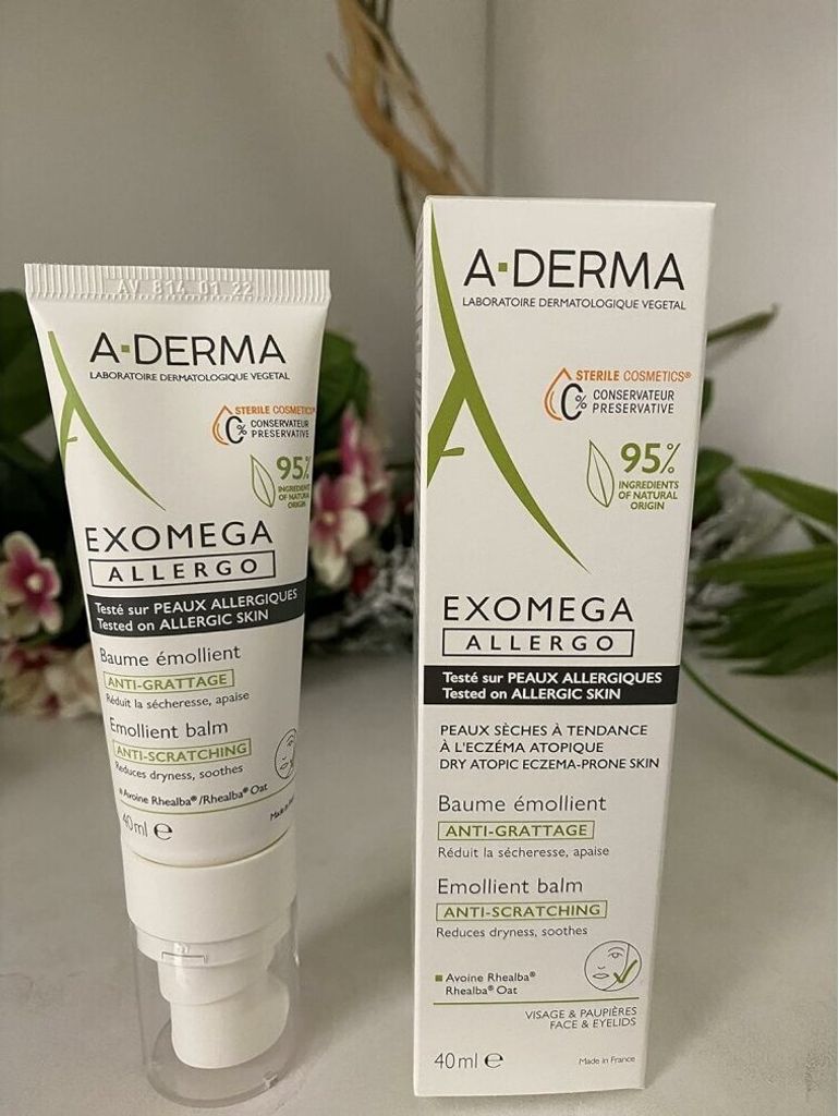 A product shot of a skincare product and its box, with some blurred foliage in the background.