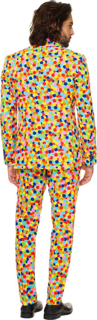 A man wearing a colorful confetti-patterned suit, viewed from the back.