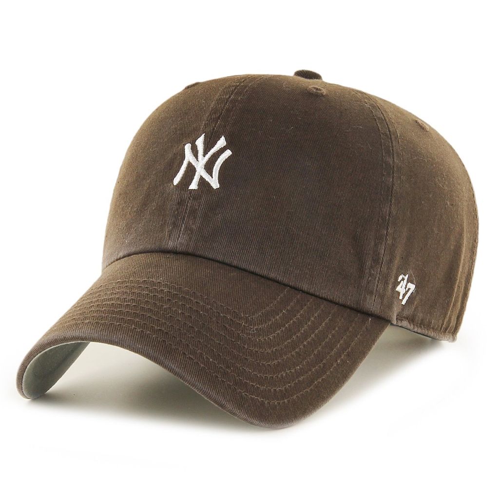 A brown baseball cap with a white New York Yankees logo and a '47 logo on the side, isolated on a white background.
