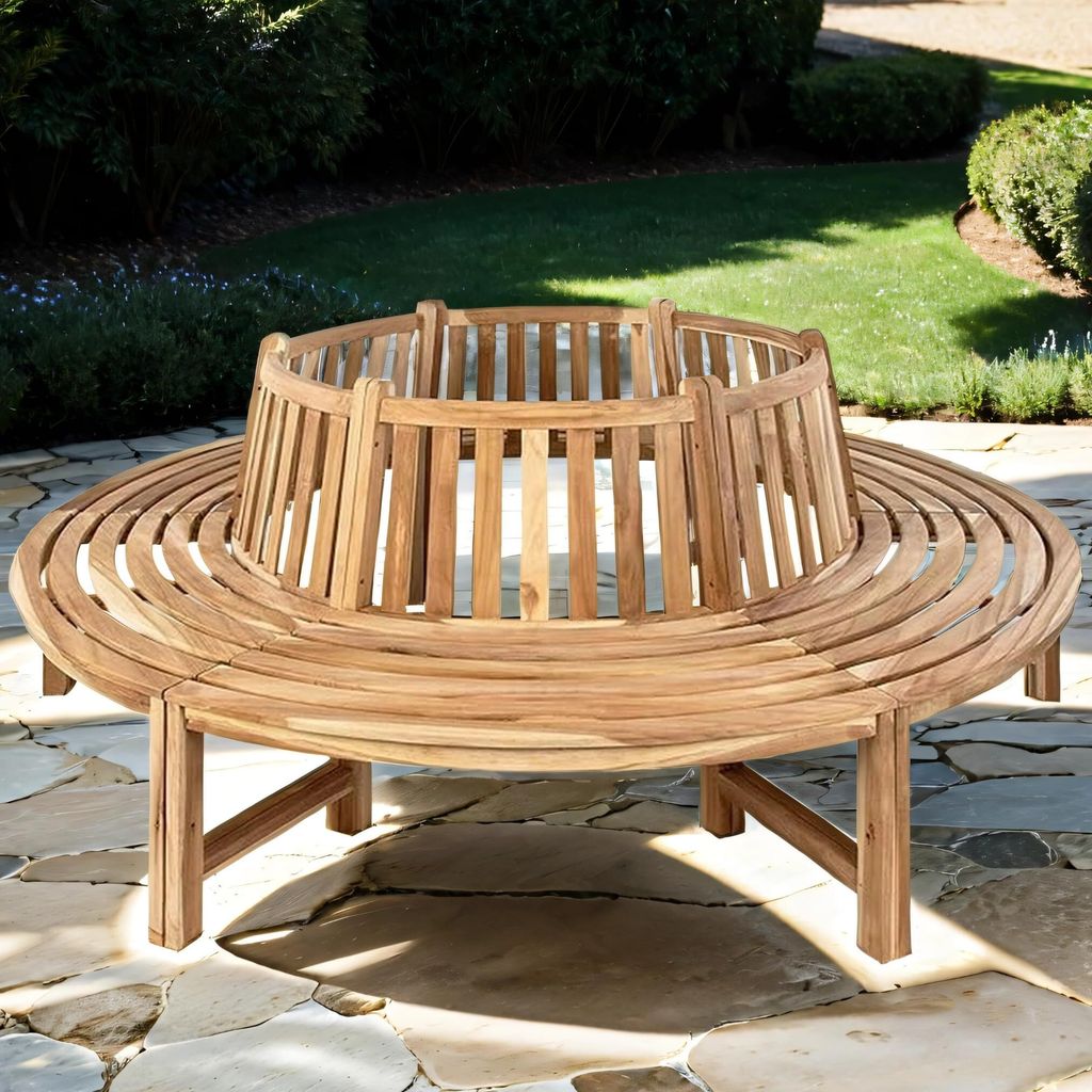 A circular wooden bench is placed on a stone patio in a garden setting.