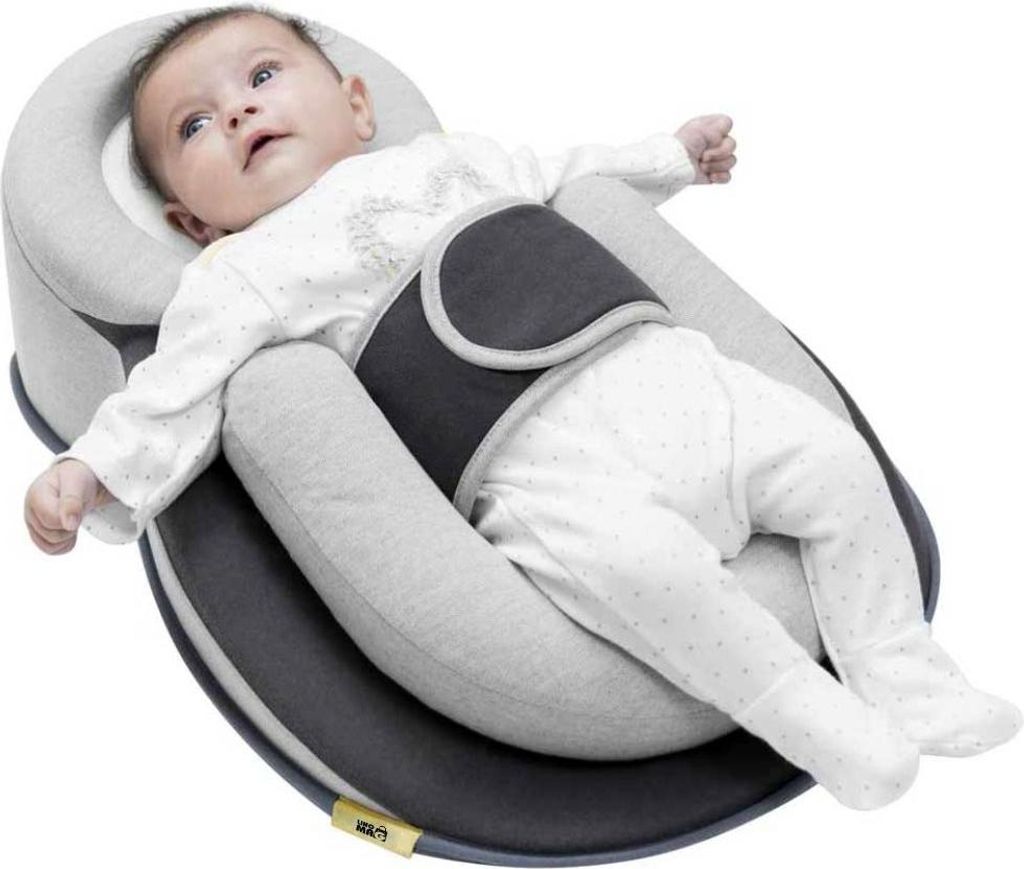 A baby lying in a specialized sleeping aid.