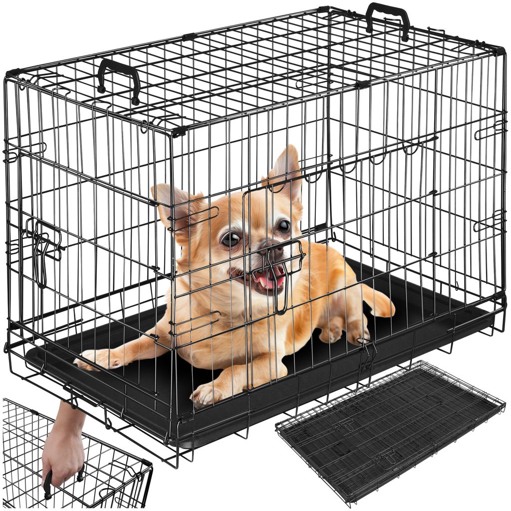 A chihuahua dog is inside a black wire dog crate. A hand is shown reaching for the crate's handle.