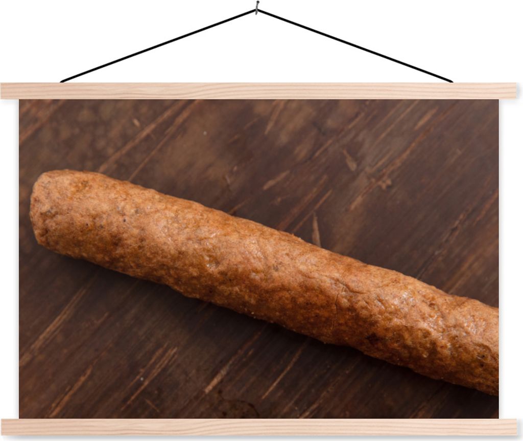 MuchoWow Textilposter Ein leckerer Frikandel auf einem hölzernen Hintergrund 120x80 cm mit holzfarbenen Rahmen - Aufhängeset