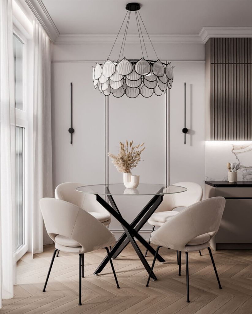 A dining room setting with a glass-top table and chairs, a chandelier, and wall sconces.