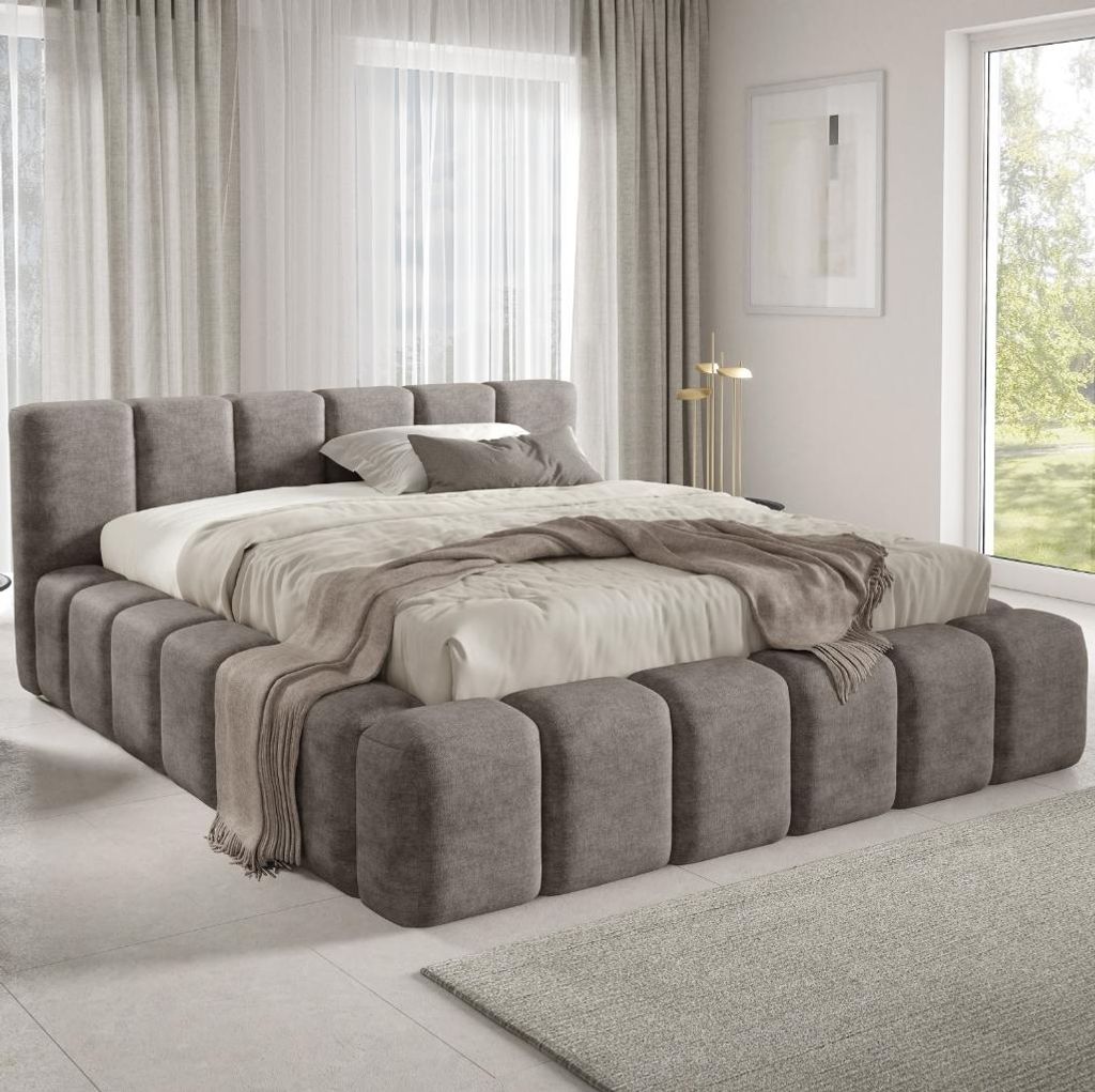 A modern bedroom with a large upholstered bed.