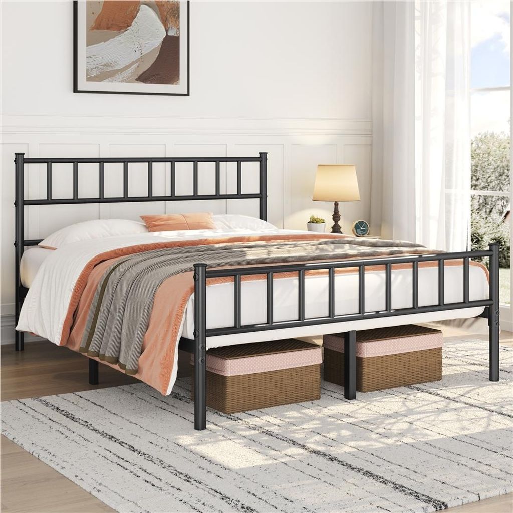 A black metal bed frame with a mattress and bedding is shown in a bedroom setting.