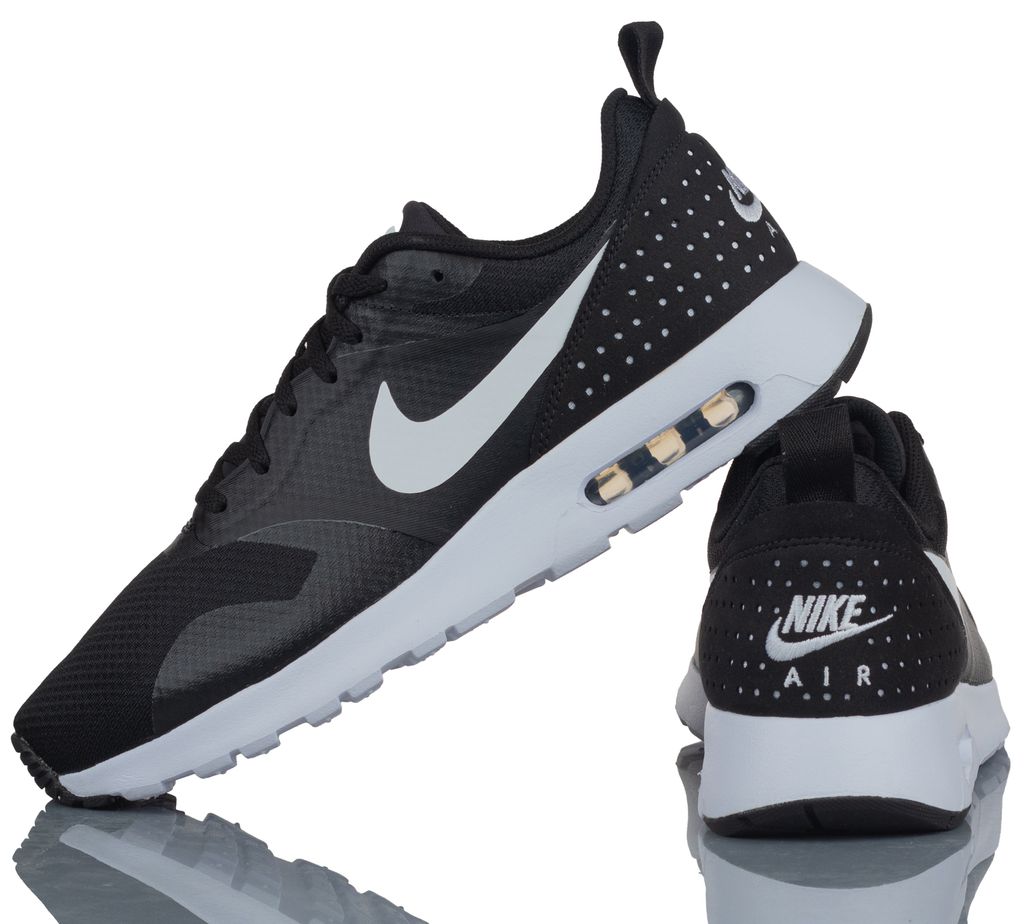A pair of black Nike Air Max Tavas sneakers are shown against a white background.