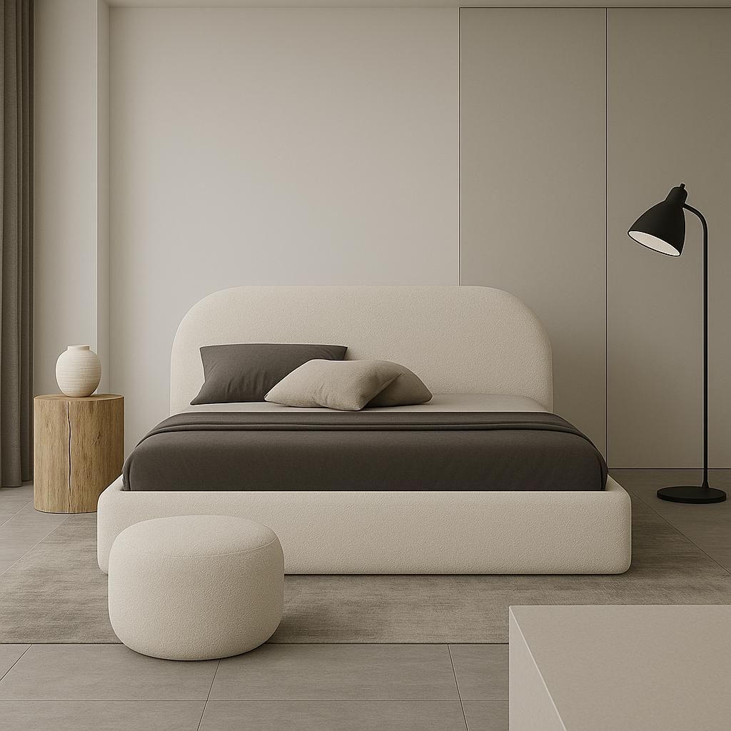A minimalist bedroom with a large upholstered bed, a side table with a vase, and a floor lamp.