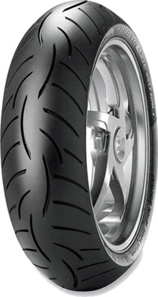A close-up studio shot of a motorcycle tire mounted on a silver rim, against a white background.