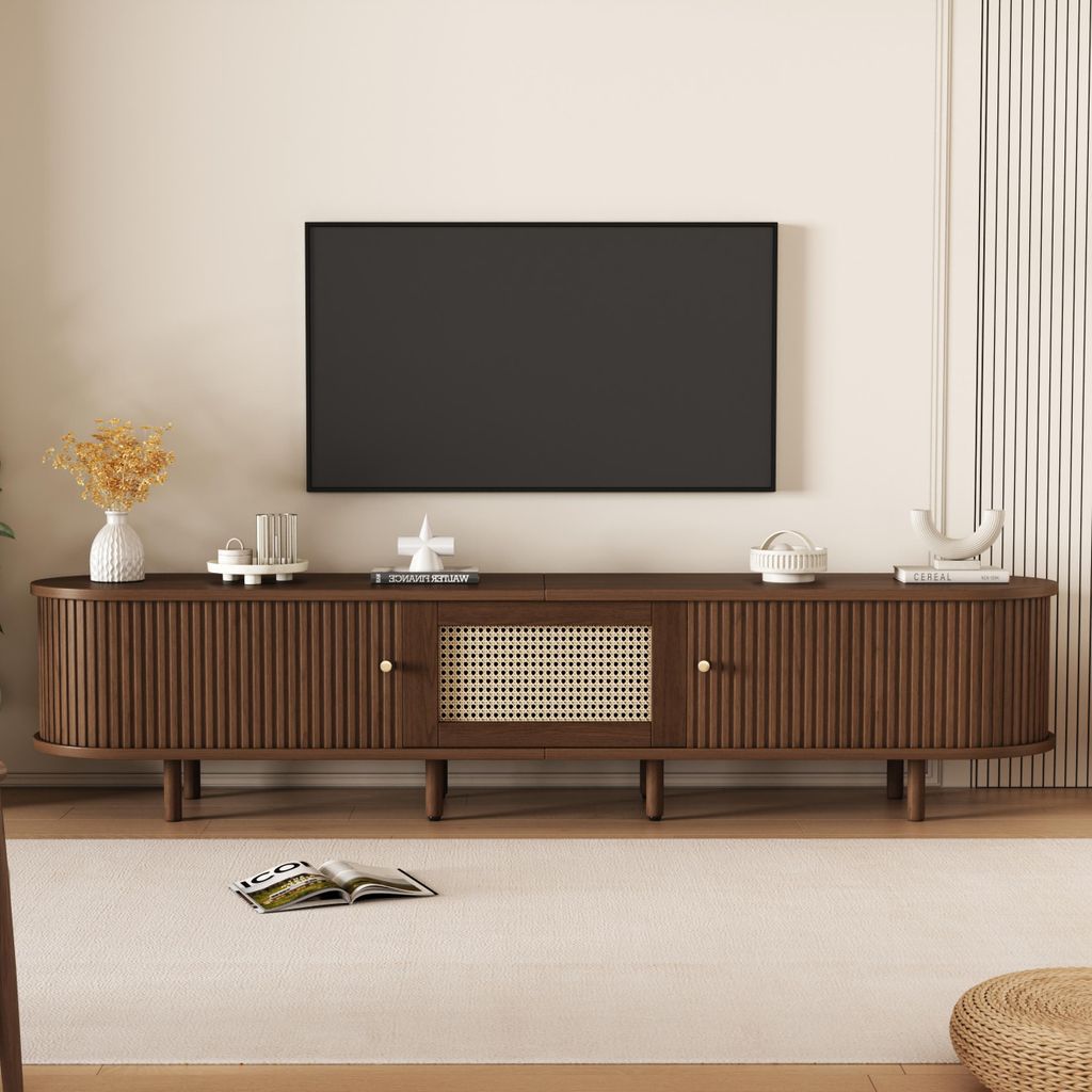 A modern living room with a TV stand and a television mounted on the wall.
