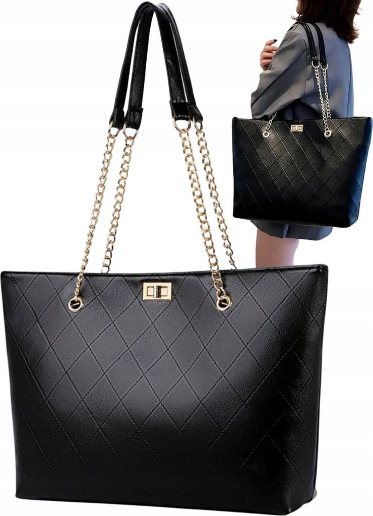 A woman is holding a black leather tote bag.