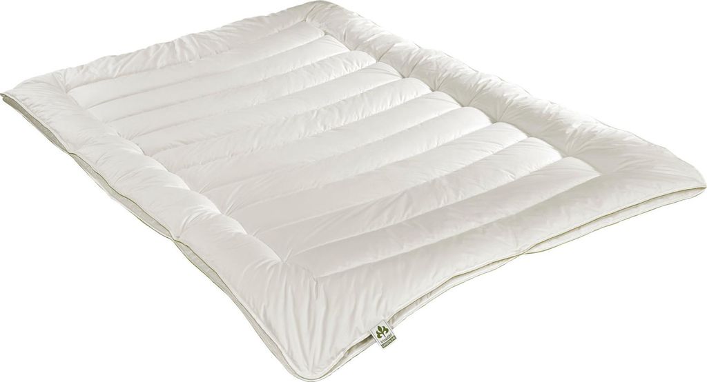 A white comforter or duvet laid flat on a white background.