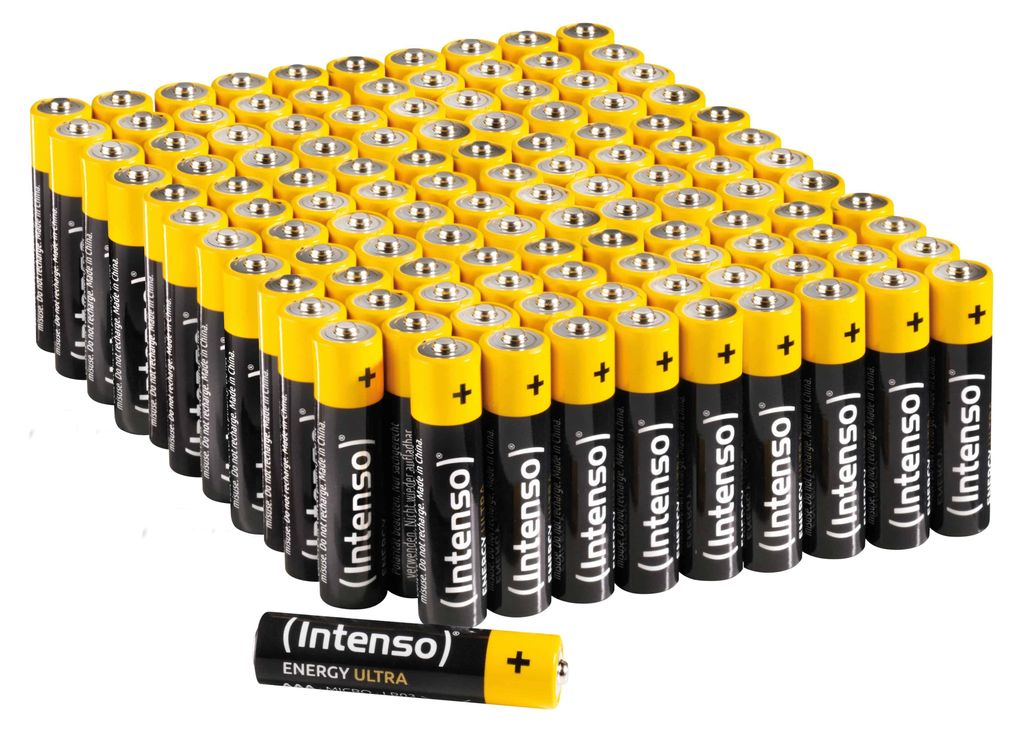 A large pile of AAA batteries, with one battery in the foreground.