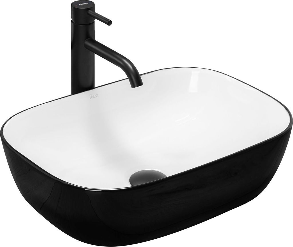 A black and white vessel sink with a black faucet.