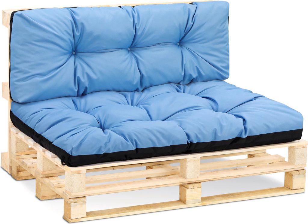A light blue cushion set on a wooden pallet.