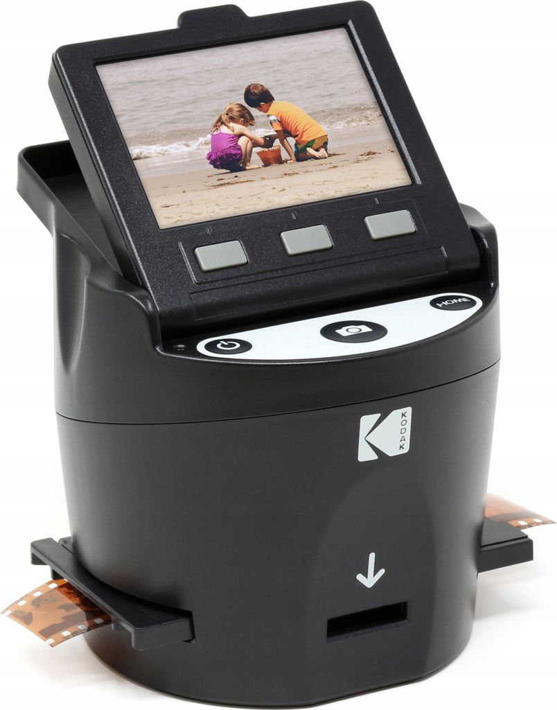 A Kodak film scanner is shown on a white background. The scanner has a screen displaying a photo of two children on a beach.