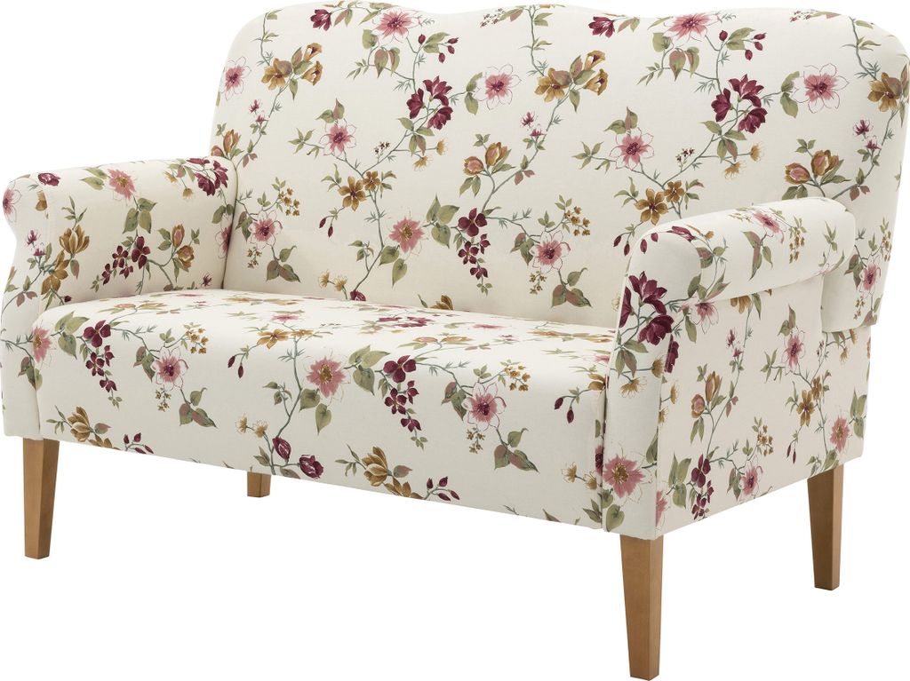 A floral patterned loveseat on a white background.