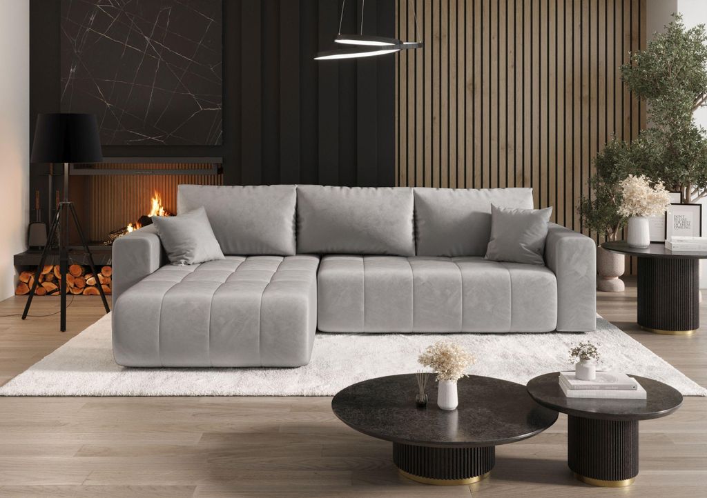 A modern living room with a large sectional sofa, fireplace, and coffee tables.