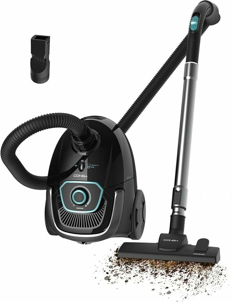 A black vacuum cleaner with its accessories and a pile of dirt being vacuumed.