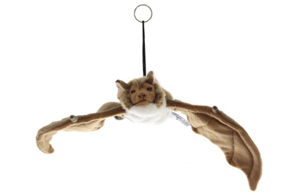 A plush toy bat hanging from a string against a white background.