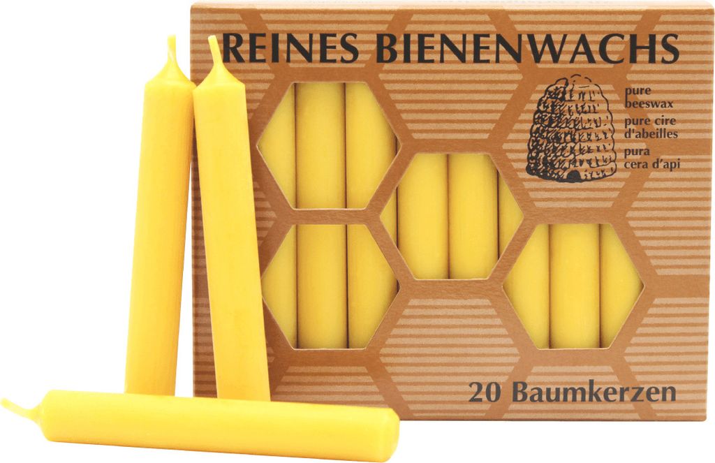 A box of beeswax candles with some candles in front of it.