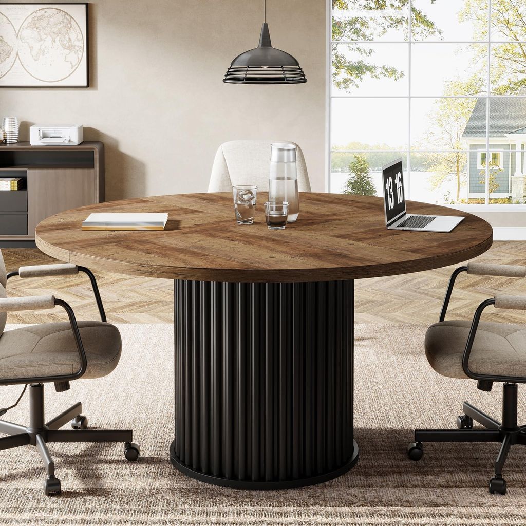 A round conference table with chairs in a modern office setting.