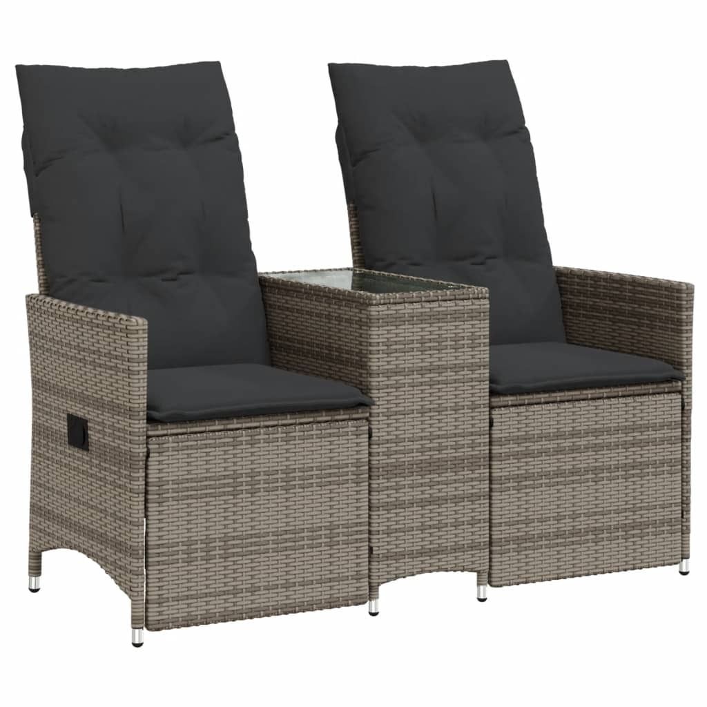 A studio shot of a two-seater outdoor sofa with cushions and a central table.