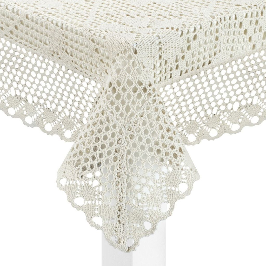A close-up view of a crocheted tablecloth draped over a table corner.