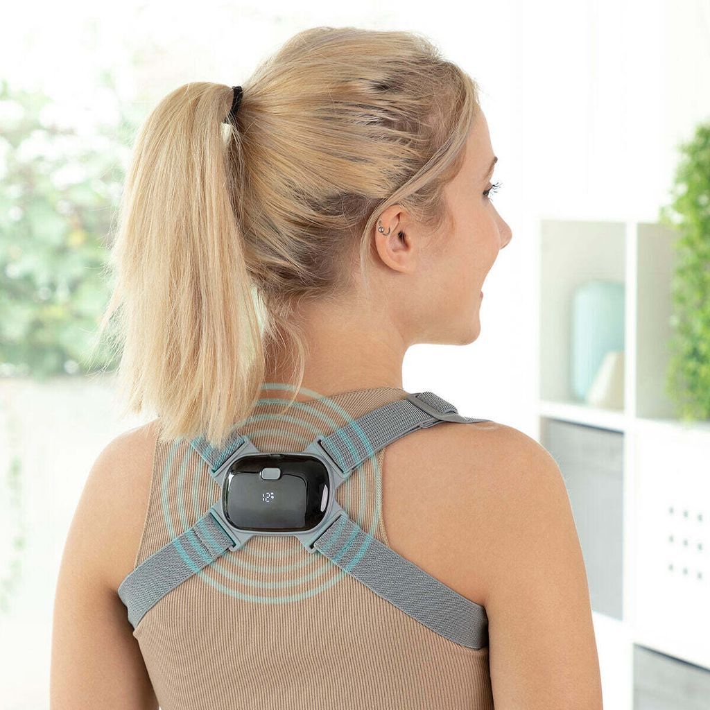 A woman wearing a posture corrector device on her back.
